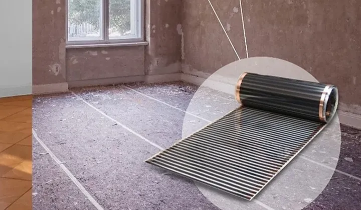 A roll of carbon heating film being laid across a prepared floor