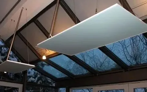 Flat radiant heating panels suspended below a ceiling