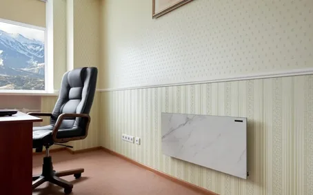 A stone-look radiant panel mounted on an office wall